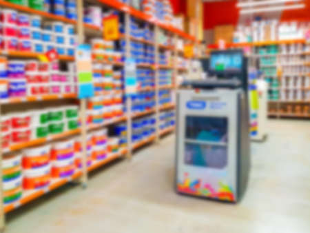 Blurred background. Shelves with goods. Sale of paint for repair. Sale of chemistry. Score. Hypermarket Paint in cans on store shelves.の写真素材