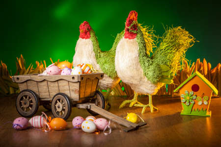 Chicken and rooster with Easter eggs. The Feast of Easter. Decorated Easter eggs.の写真素材