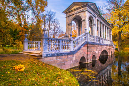Autumn trees. Autumn weather. Bridge over the creek. Yellow trees on the shore of the lake.の写真素材