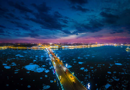 Russia is the beginning of winter in St. Petersburg. Ice drift on the Neva River. Bridges of Petersburg. Trinity Bridge over the Neva River. Evening view of the city of St. Petersburg.の写真素材