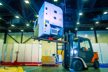 The forklift lifts the equipment. Transportation of industrial equipment. Unloading equipment. The...