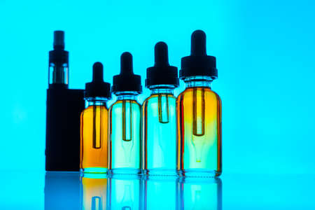 Vaping mod e-cig with tank atomizer and juice bottles. vaping deviceの写真素材