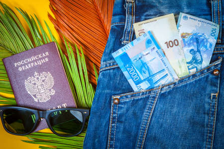 Russian tourism. Money for travel. Money for travel around Russia. Russian Federation. Money peeps out of his pocket. New banknotes of rubles. Passport and money of Russia.の写真素材