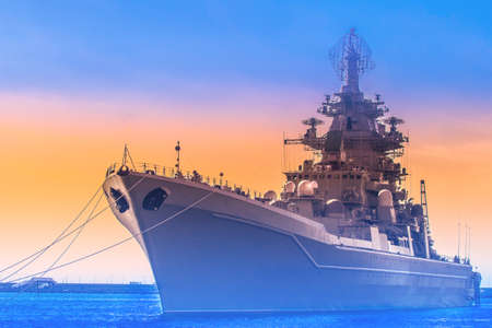 Warship Ship on sunset background. Military naval forces. Contour of the cruiser.の写真素材