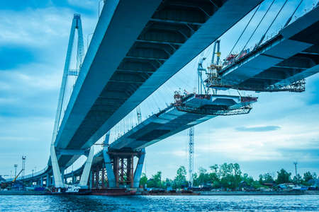 Construction of a bridge across the river. The long bridge. Metal structures. High bridge. Highway construction.の写真素材