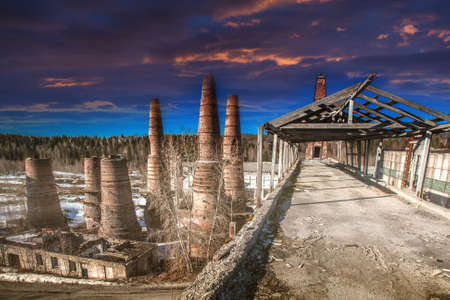 Abandoned factory. Collapse of buildings. Pipe factory. Abandoned production. Pipes made of bricks. Territory of the enterprise.の写真素材
