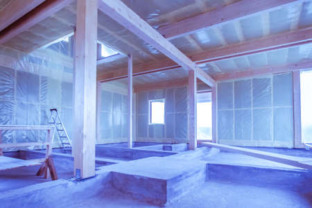 Construction. Insulated walls. Home construction. The walls are insulated and covered with foil. Construction works. The frame of the house. The frame of the cottage with the warming of the walls.の写真素材