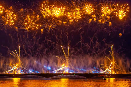 Fireworks on the bridge. Golden fireworks. Salute above the river. Celebration Festive salute.の写真素材