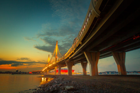 Highway. Road on sunset background. The highway passes into the bridge. The highway goes along the...