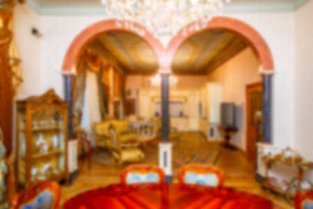 Blurred background of the living room. Living room with arches. Antique furniture. Room with arches....