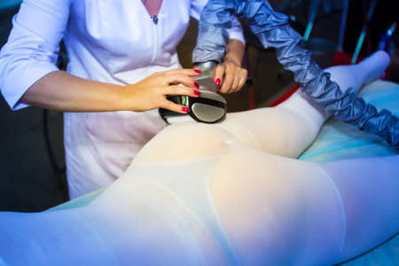 Vibro massage for women. Massage for weight loss. Vacuum body massage. The girl takes the procedure of vacuum massage.の写真素材