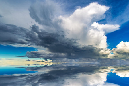 The clouds are reflected in the water. Calm. Reflection of the sunset in the water. Reflection.