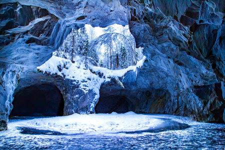Winter Cave. Snow-covered cave. The Republic of Karelia. The village of Ruskeala. Karelia in the...