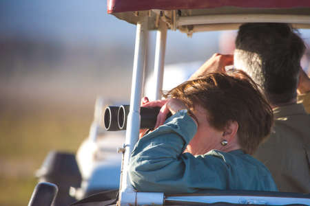 Car tourism in Africa. People are watching the animals of Africa. Traveling by car.の写真素材