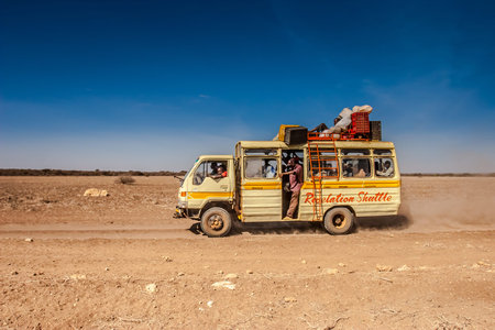 Passenger transportation of people in Africa. A bus with people travels in Kenya towards the city of...