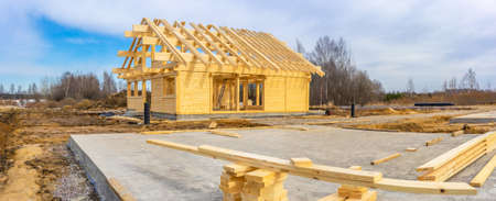 Panorama of the construction site. The foundation for the house. The frame of the cottage. Construction of the Cottage. Panorama of building a house.の写真素材