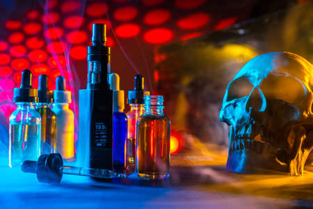 Liquids for electronic cigarettes. Skull with liquids for Vape. Harm to smoking. The harm of electronic cigarettes.の写真素材