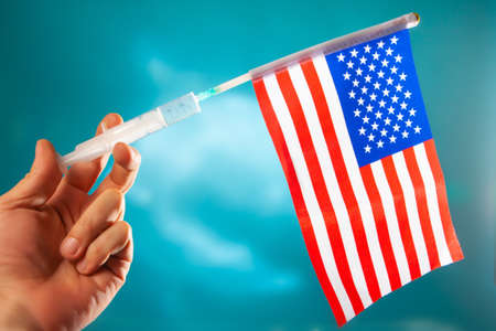 The US flag on a syringe. Medicine in the USA. Medical services in the United States to America.の写真素材