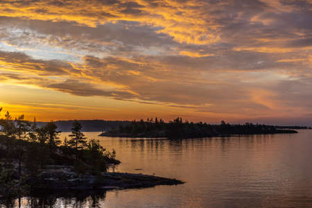 Clouds over the water. Sunrise. Gold clouds. Karelia Russia. Nature of Karelia. Ladoga lake.の写真素材