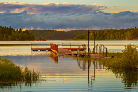 Quay against the background of the forest. Wooden pier on the lake. Pier.の写真素材