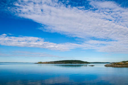 Island. Clouds over the island. Karelia. Ladoga lake. Summer day in Karelia. Russia.の写真素材