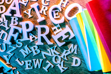 A pack of books. Color books surrounded by letters. Concept on the topic of education. language training.の写真素材