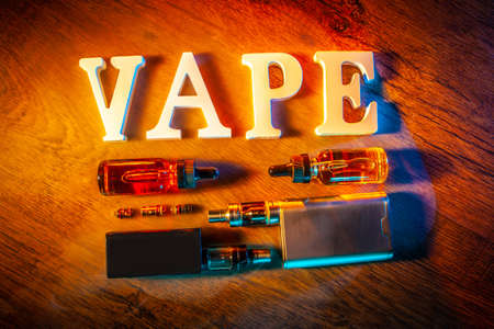 Popular vaping device mod. vape. vape smoke. The electronic cigarette is on the table. Liquids for VAPEの写真素材
