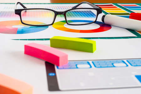 Color selection. Table where ux works Graphic designer. Application development for phones and tablets. Colorboard is laid out on the table. Glasses on the table.の写真素材