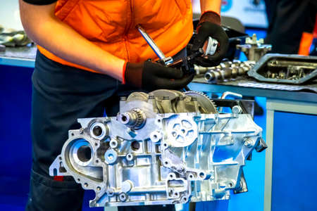 Locksmith Car service. Engine repair. An employee car service makes analysis of the engine. Motor cars disassembled.の写真素材