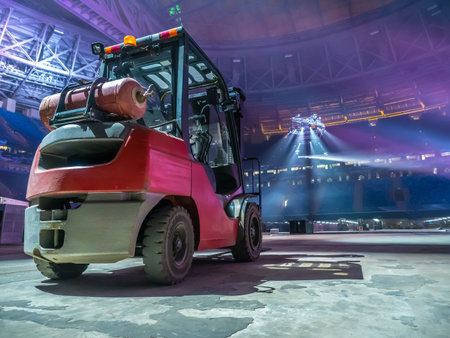 Stacker. Construction site. Forklift. Spotlights on the construction site. Hydraulic loader in the...