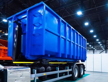 Dumpster on the car. Garbage removal. Dump semitrailer. Trailed equipment. Trucks. Special machinery. Dump truck transportation of bulk cargo. Freight transport industry.の写真素材