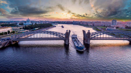Saint Petersburg. Russia. Bolsheokhtinsky bridge lifted. Bridge of Peter the Great at sunset. The drawbridges of Petersburg. Navigation on the Neva River. Cities of Russia. Panorama of St. Petersburg.の写真素材