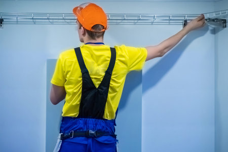 Builder worker install metal construction. Installation of metal profile on the wall. Repair of...