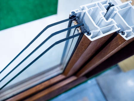 Double-glazed window for plastic windows in the section. Profile of metal-plastic windows. PVC profile for windows. Three-chamber window profile. Installing double-glazed windows.の写真素材