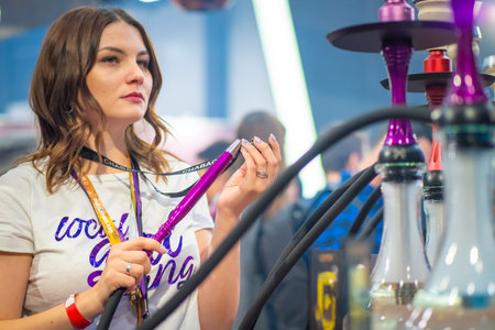 The girl is preparing a hookah. Smoke. Service. Smoking accessories. Tabaka. Hookah Club Show....