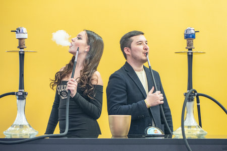 A man tastes the scent of hookah tobacco. Smoke. Smoking accessories. Tabaka. Hookah Club Show. Exhibition of hookahs. 9.3.2019. Russia. Saint Petersburgのeditorial素材