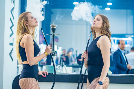 Woman smokes a hookah. Smoke. The girl tastes tobacco. Smoking accessories. Tabaka. Hookah Club...