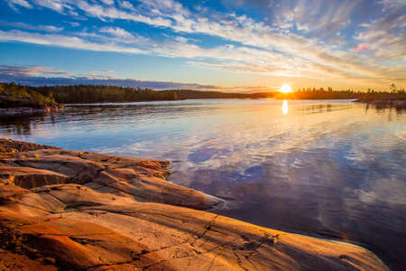 Reflection of the sky in the water. Dawn. Wildlife of Karelia. Ladoga lake. Travel to Russia. Republic of Karelia. Islands on the lake. Northern nature.の写真素材