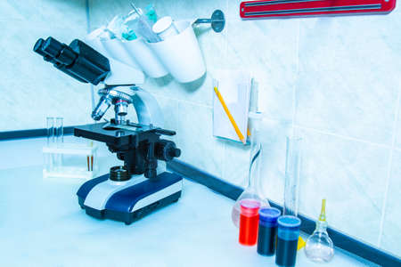 Microscope. Microscope with flasks and reagents in the laboratory. Optical instruments. Professional optics. Laboratory research. Scientific equipment.の写真素材
