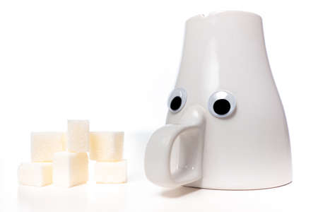 Emoji Metaphor - Sugar deficiency.Tea cup with eyes. Concept - Lack of sugar in the body. Glucose deficiency.Low blood sugar. Blood glucose meter A glass with eyes next to sugar.Reduced glucose levelsの写真素材