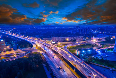 Highway over the city. Evening highway with cars. Highlight on high-speed highway.の写真素材