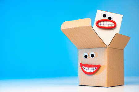 Emoji - packaging. Concept - Quality packaging of goods. Packing with emotions. Sale of packaging materials. Production of package materials. Boxes for Package. Packing with eyes and a smile.の写真素材
