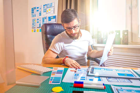 Ux ui design. The graphic designer selects the layout of the mobile app. The process of prototyping in software development. Visualization of the prototype application for the smartphone. Wireframing.の写真素材