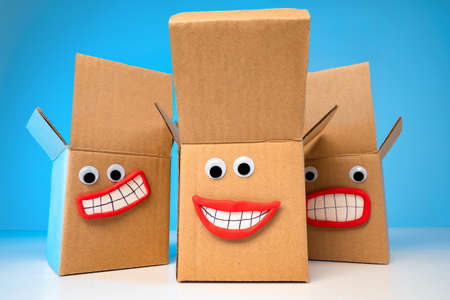Emoji. Forwarding services. Boxes with eyes and a smile. Concept - good storage conditions. Boxes depict joy. Delivery of cargoes. Forwarding. Storage of goods. Services for the transport of goods.の写真素材