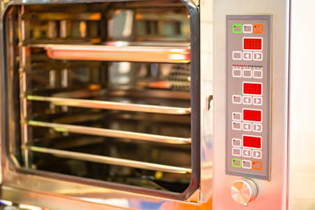 Open oven on food production. Professional kitchen equipment for restaurants and cafes. Food industry.の写真素材