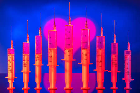 Symbol of the heart on the background of syringes.の写真素材
