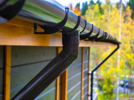 Holder gutter drainage system on the roof. Drain on the roof of the house. Roof drainage. Water...