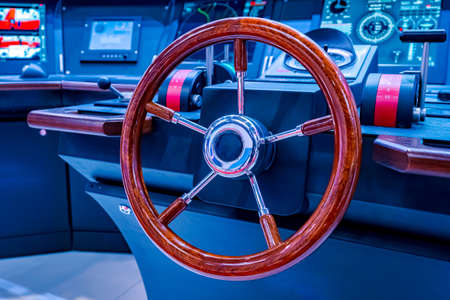 Steering wheel on the remote control ship. Steering wheel and ship throttles on the captains bridge. Modern ship control panel.の写真素材