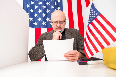 Presidential elections 2020 in America. An American reflects on filling out a ballot. A man fills...