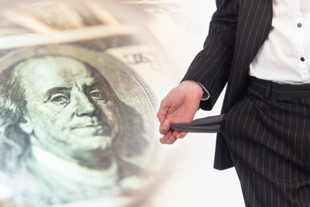 Poverty. Bankruptcy. A man shows empty pockets against the background of the dollar. Lack of...